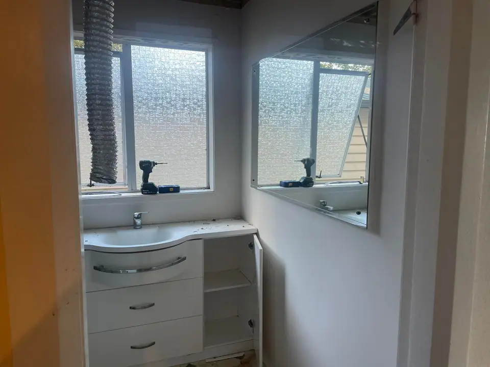 Bathroom vanity and mirror installed during a renovation