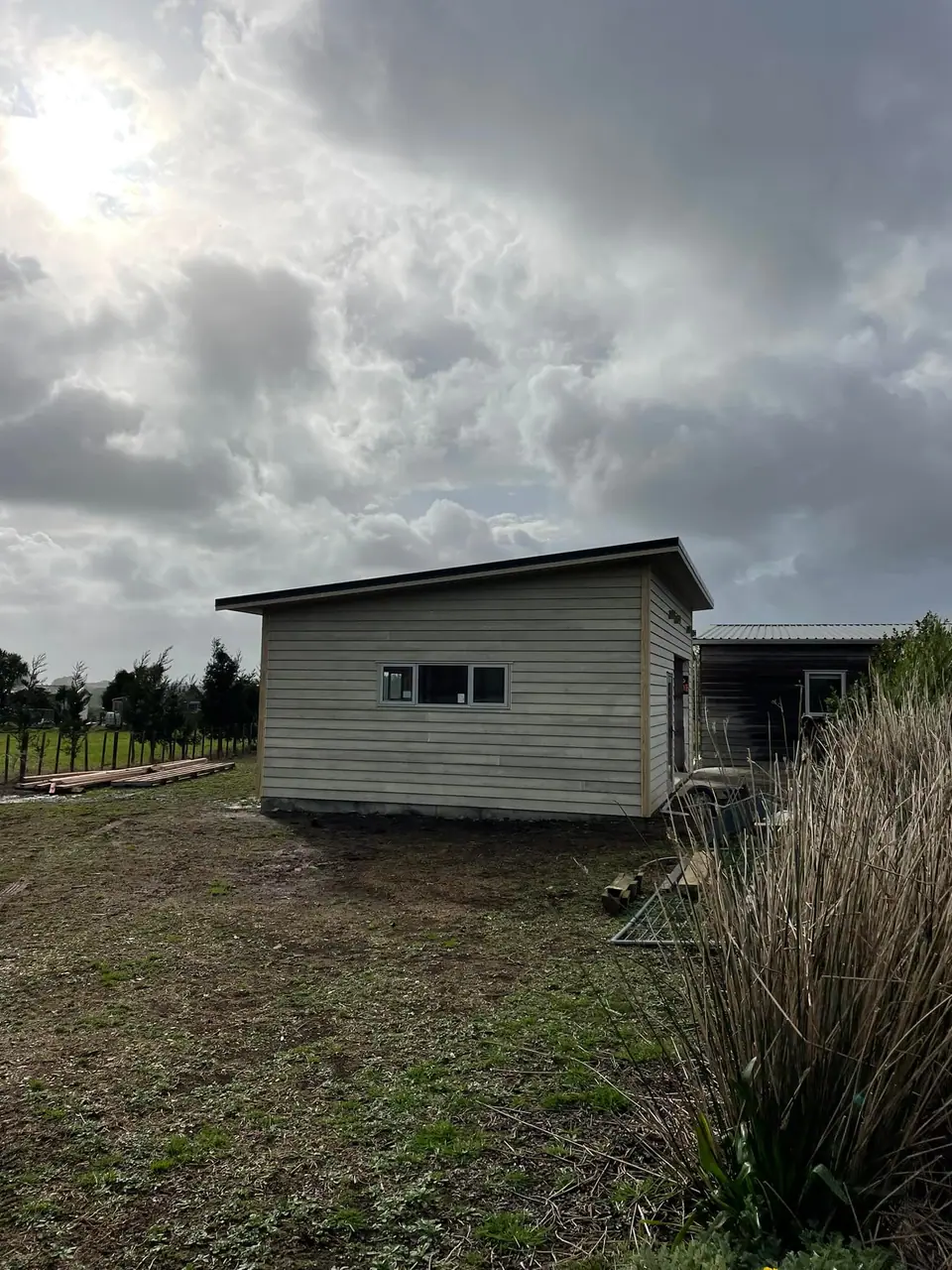 Small weatherboard cabin on a rural property