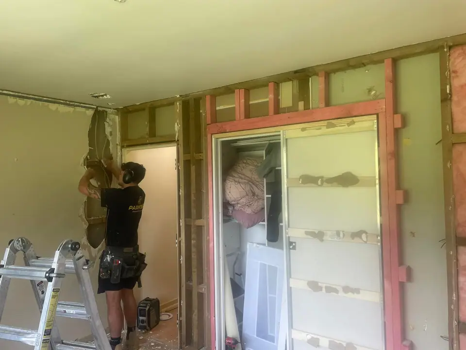 Builder forming a new doorway during an interior alteration