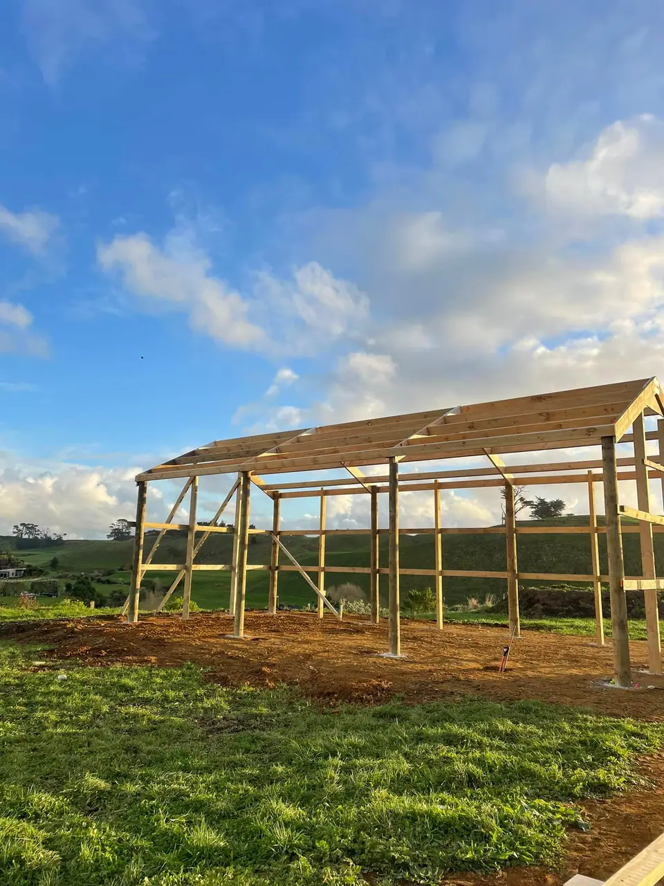 Pole frame shed framing going up on a rural property