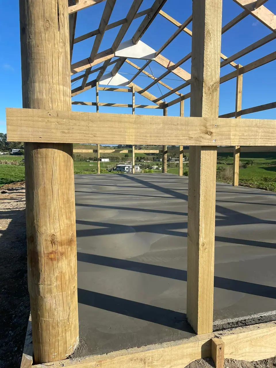 Treated timber poles set for a new pole shed