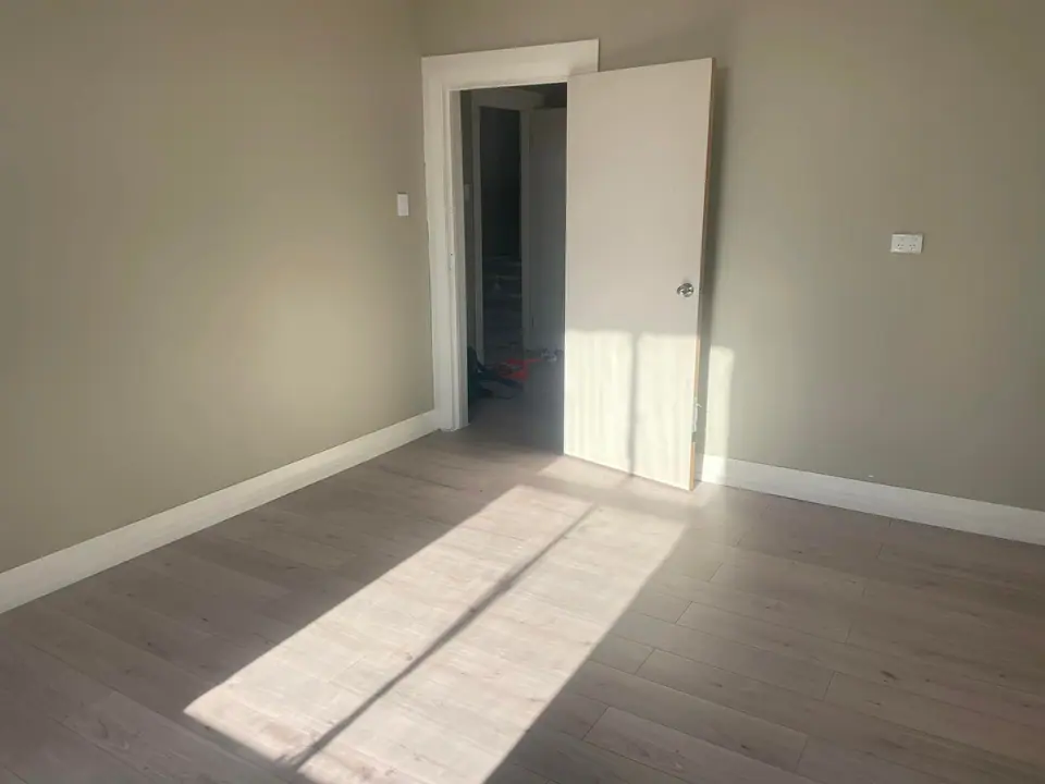 Freshly renovated bedroom with new flooring and trims