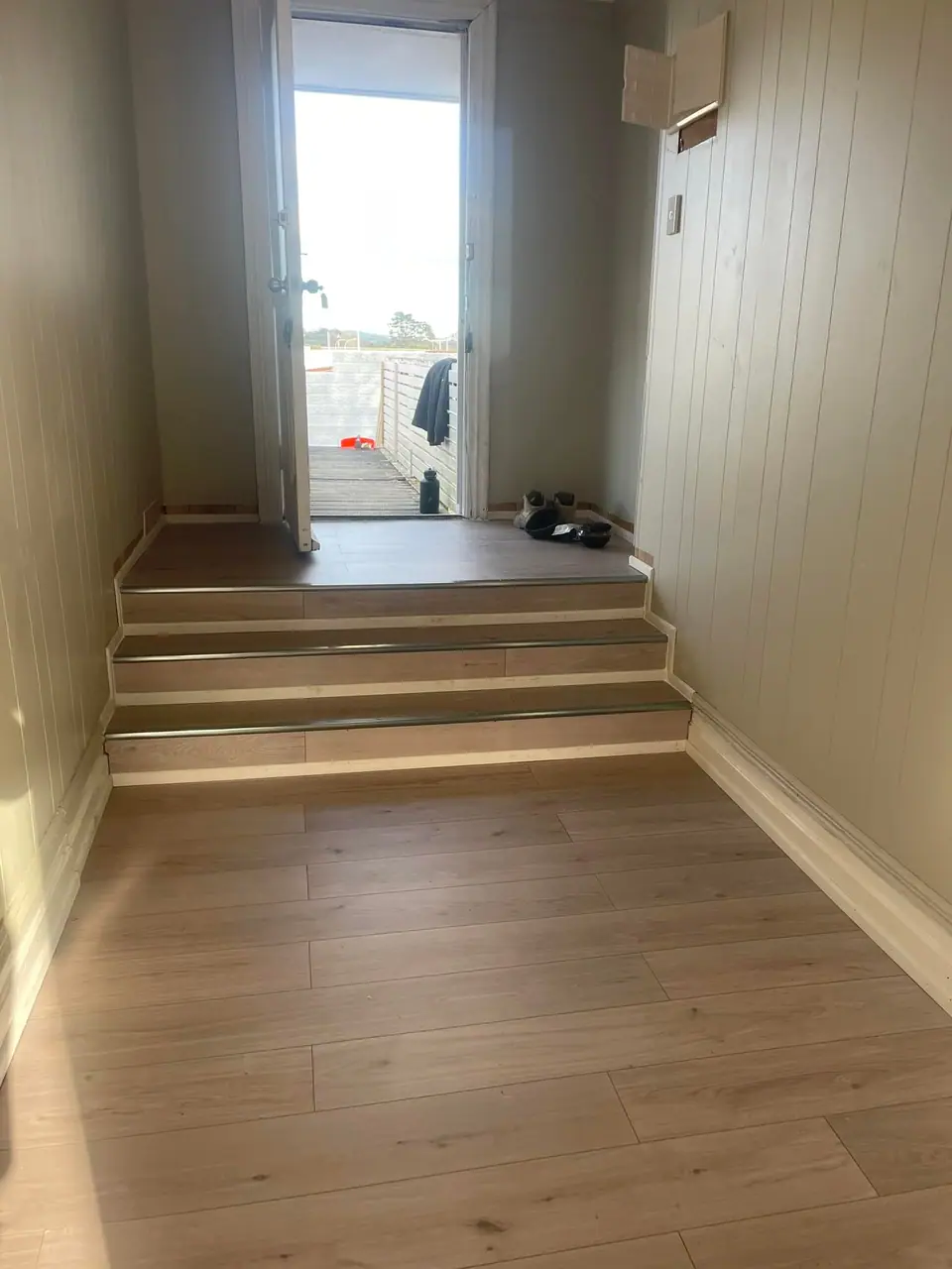 Renovated hallway with new steps and timber-look flooring