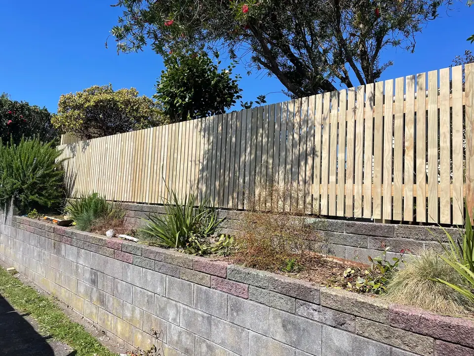 New timber fence built above a block retaining wall