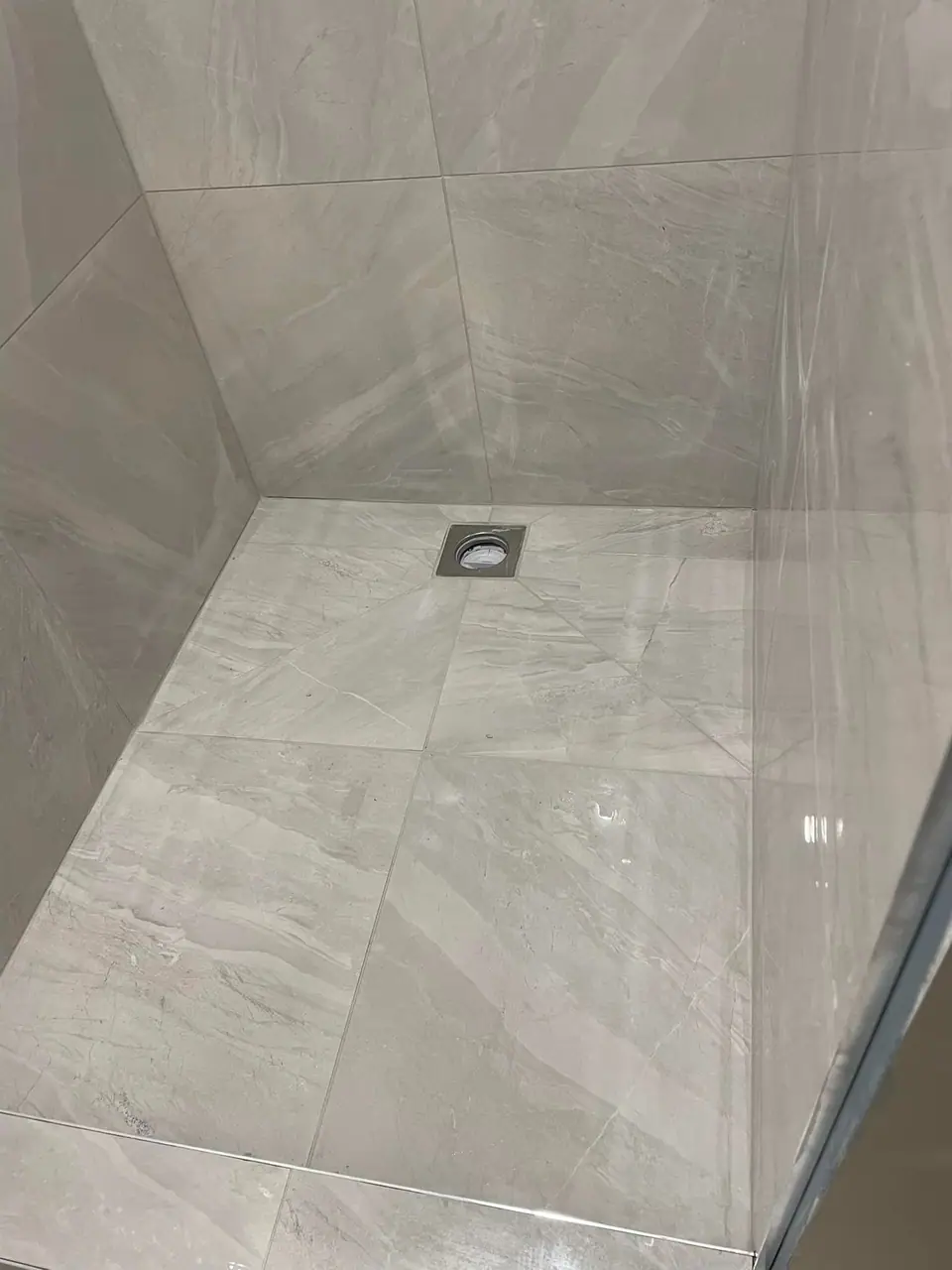 Tiled shower floor with centre waste during a bathroom renovation