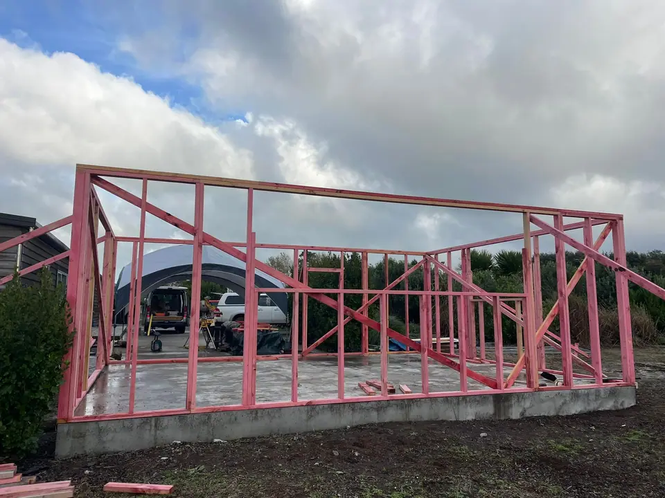 Timber wall framing standing on a new concrete slab